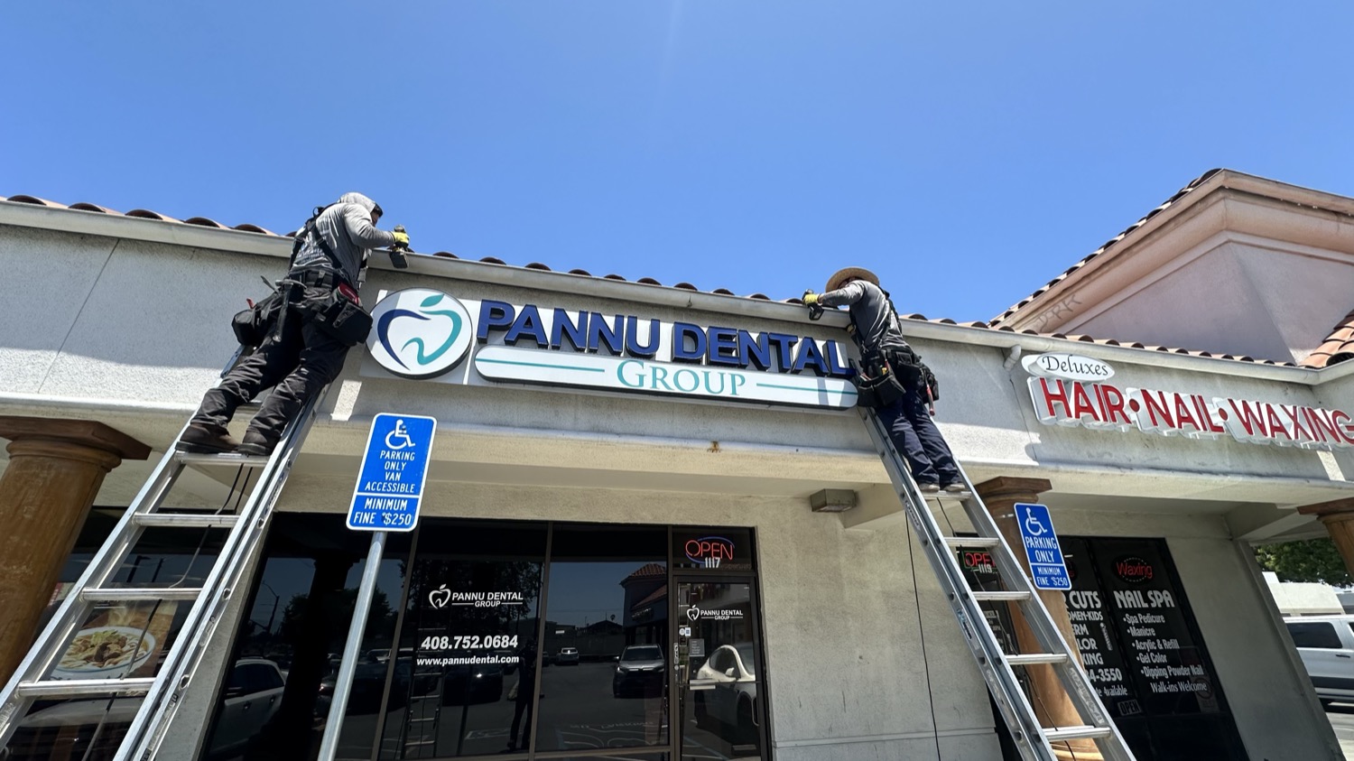 Resolution Gutter crew installing gutters on a commercial building in the Bay Area